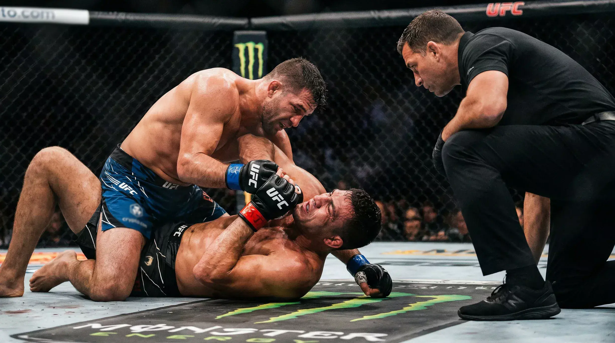 MMA-Kämpfer führt einen Bodenkampf-Griff aus im Oktagon